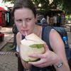 Gini slurps a coconut. Quite delicious!