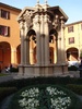 An old well in the center of one of the Piazzas