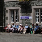 Tavistock oldies enjoying the sun as a wedding entourage forms
