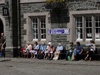 Tavistock oldies enjoying the sun as a wedding entourage forms