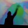 Tom making colour splatters on a digital screen at the decode exhibition, v&a museum.