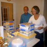 Uncle Peter looks on as Trish packages up the 100+ cupcakes