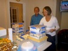 Uncle Peter looks on as Trish packages up the 100+ cupcakes