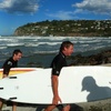 A couple of hardcore surfers emerge from the waves of Sumner Beach, Christchurch. Hardcore!