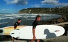 A couple of hardcore surfers emerge from the waves of Sumner Beach, Christchurch. Hardcore!