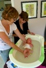 Ann, our midwife, gives Olive her first bath and she loves every minute.
