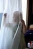 Playing peekaboo in the curtain