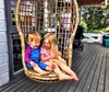 Two cuties in the swing chair.