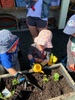 Loves hanging off the monkey bars... got into the planting and watering...
