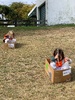 KPC Tamariki Nui: at Ben burn park, painting boxes and sliding down the hills, ball and parachute play.